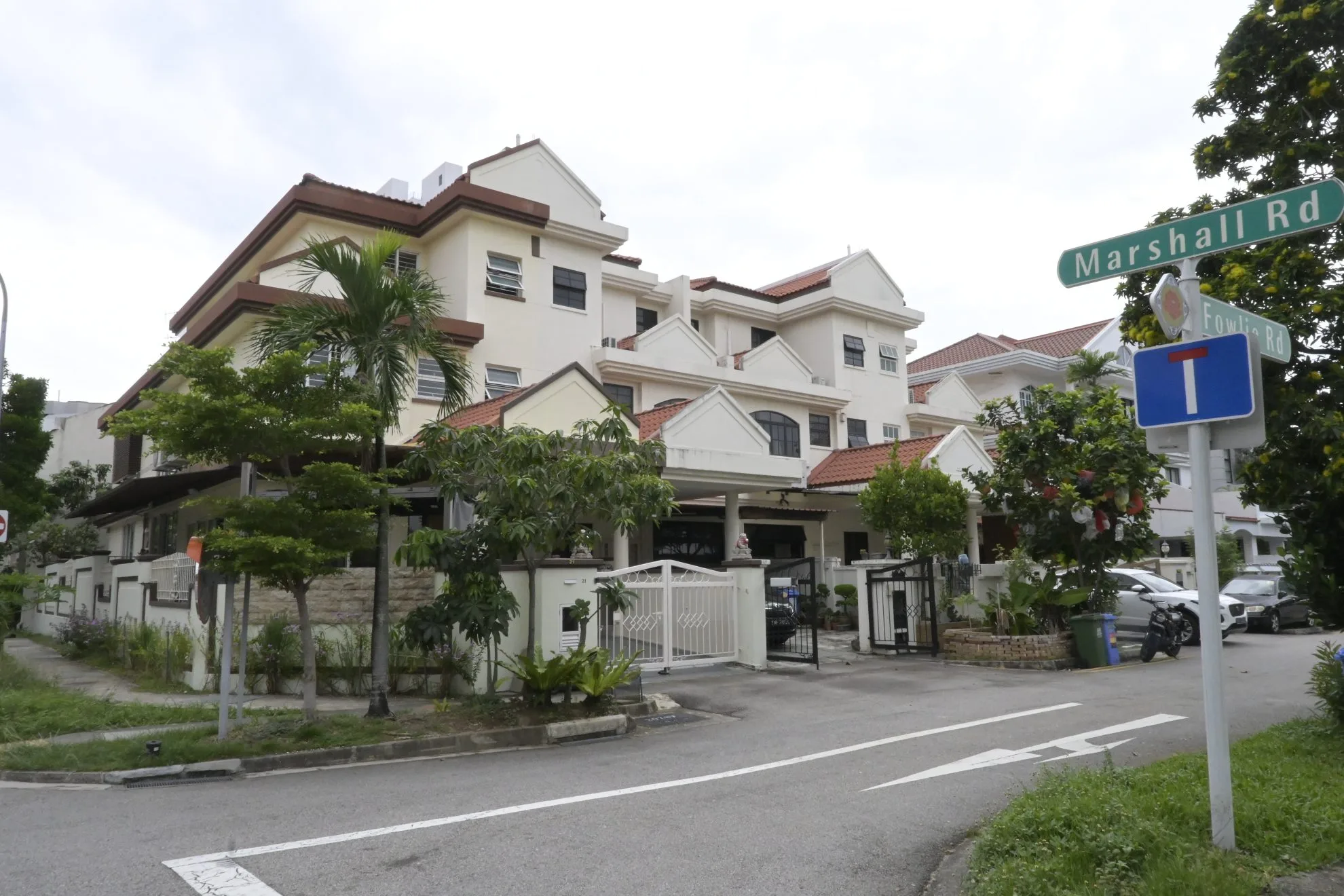 A freshly painted exterior of multi-story landed houses along Marshall Road in Singapore featuring off-white facade walls, brown trim, and tiled roofs.