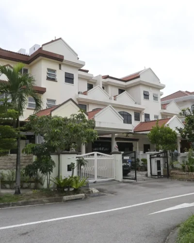 A freshly painted exterior of multi-story landed houses along Marshall Road in Singapore featuring off-white facade walls, brown trim, and tiled roofs.