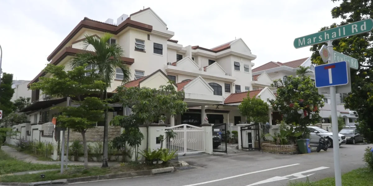A freshly painted exterior of multi-story landed houses along Marshall Road in Singapore featuring off-white facade walls, brown trim, and tiled roofs.