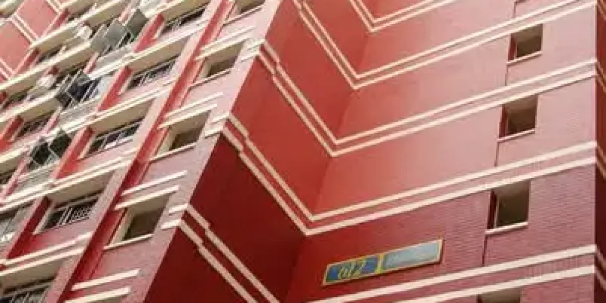 Low-angle view of a tall, red HDB residential apartment building in Singapore with white horizontal stripes and block number 612.